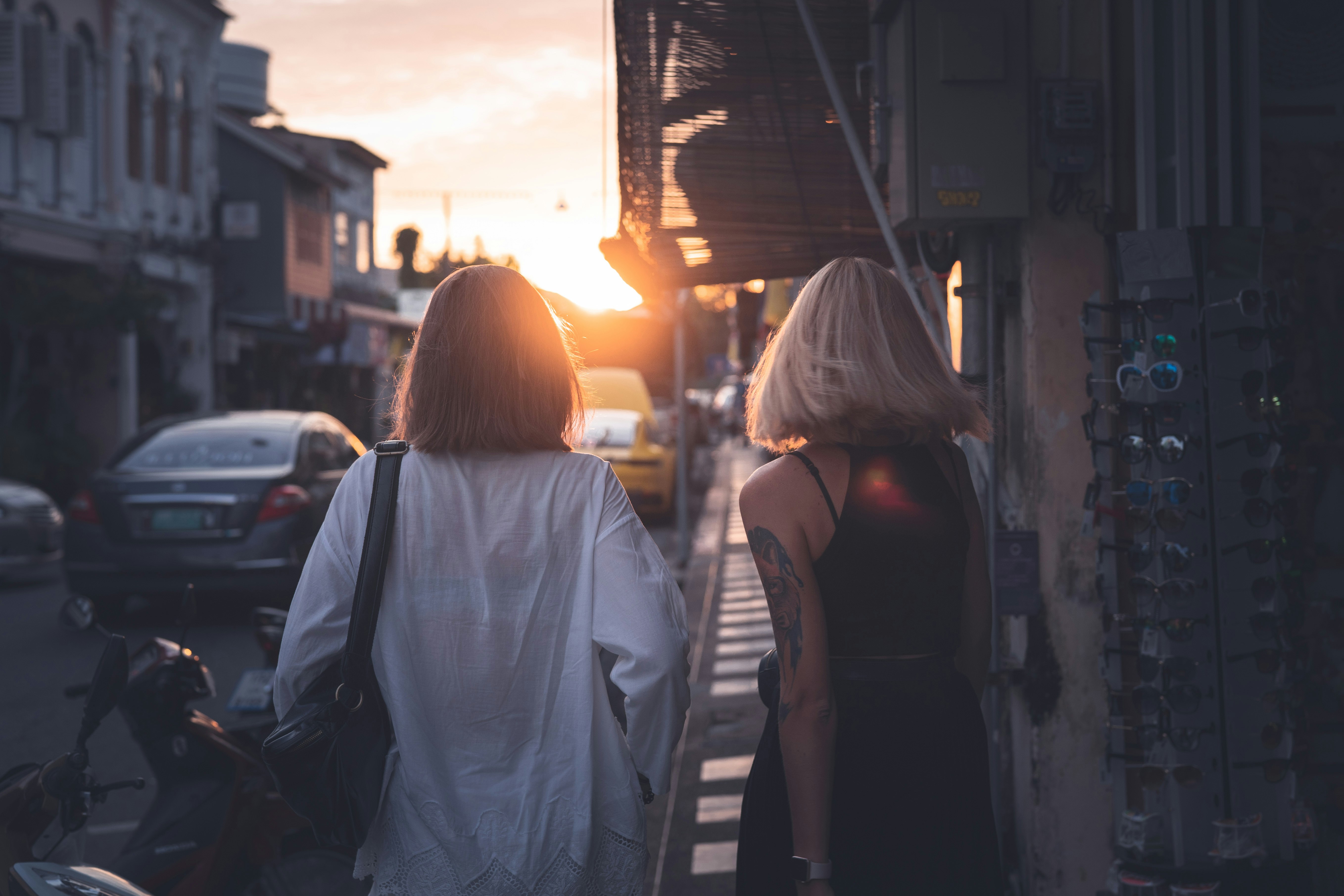 women walking on sidewalk